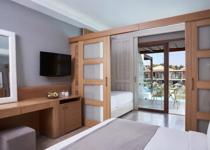 atlantica-holiday-village-rhodes-family-room-sliding-door-pool-view_13764