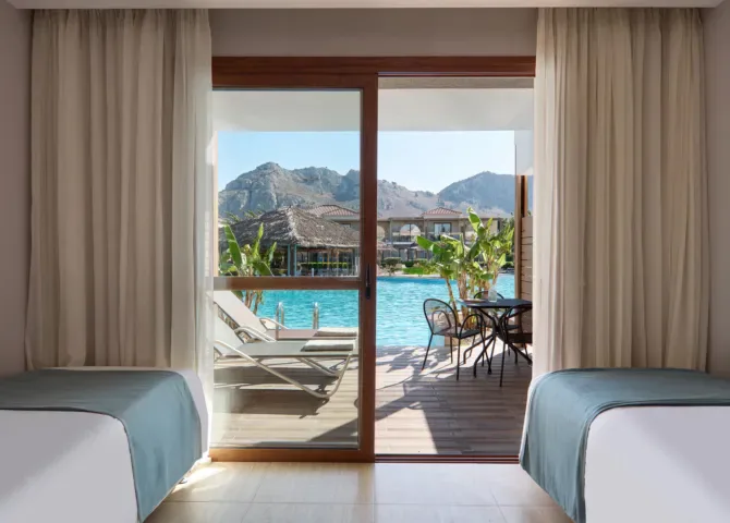 atlantica-holiday-village-rhodes-family-room-sliding-door-swim-up-pool-view_13764