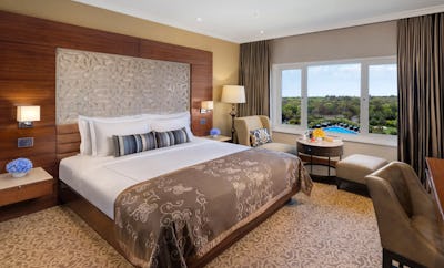 Taj Club Room King Bed Forest and Pool View